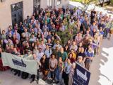 State of the Map US 2024 attendees smile for a group photo. 😊